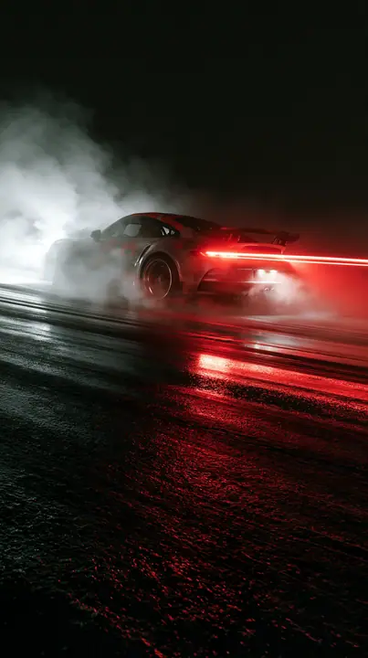 a sports car drifting on a wet track at night, tyre smoke lit red, light trails, no text, no letters, no logos