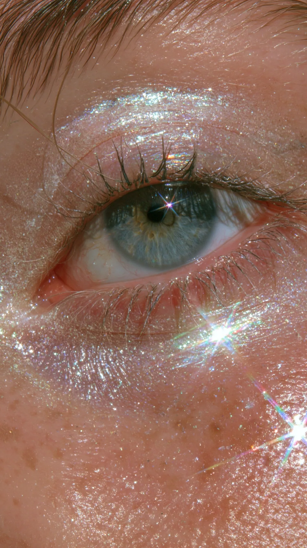 macro of iridescent glitter eyeshadow on an eyelid, sparkle, beauty editorial, no text, no letters, no logos