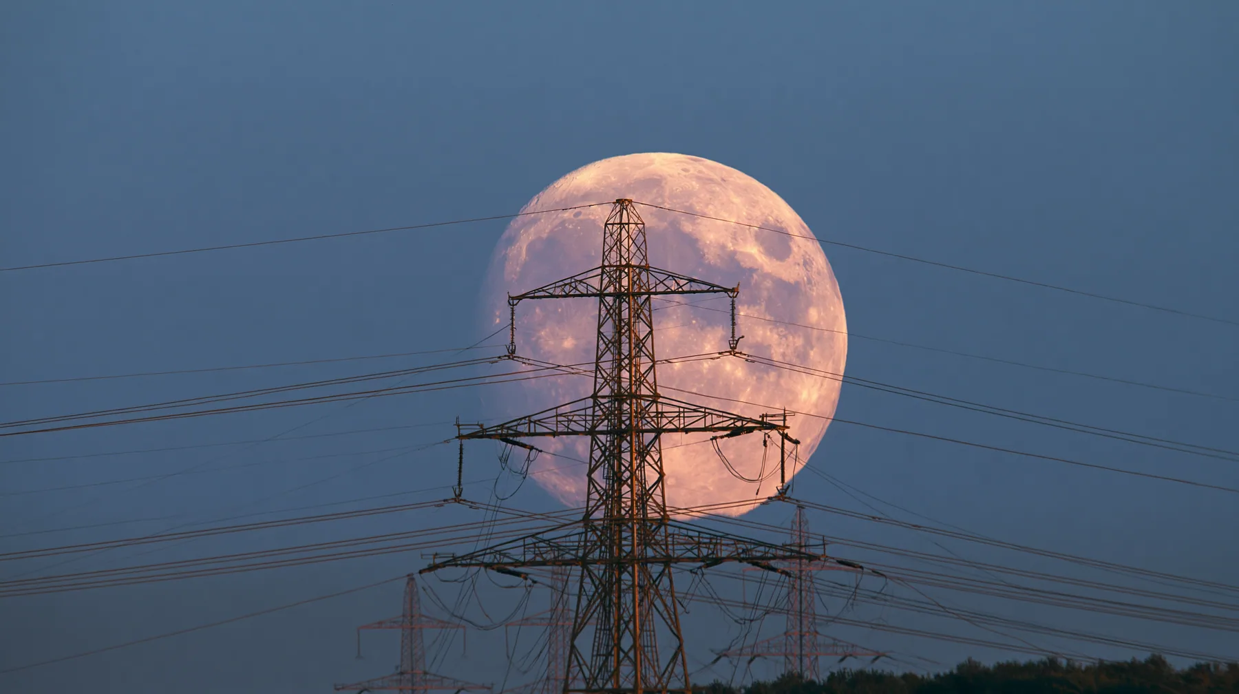 a full moon rising behind a power line at dusk, telephoto, crisp, no text, no letters, no logos