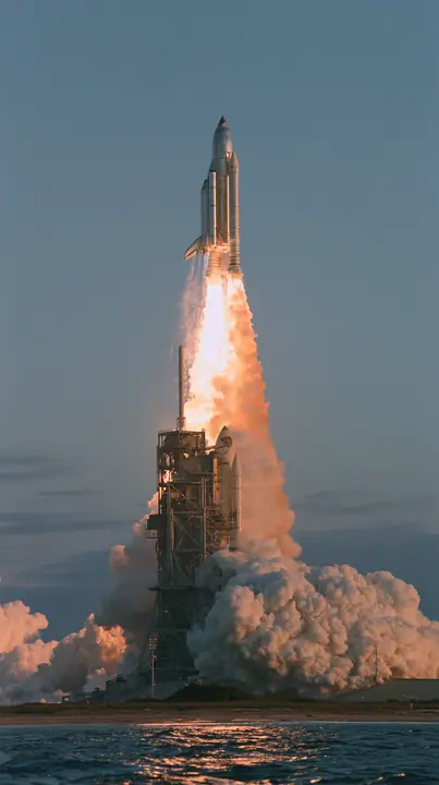 a giant stainless-steel rocket lifting off from a coastal launch tower at dawn, a towering white and orange plume, telephoto documentary photograph, no text, no letters, no logos