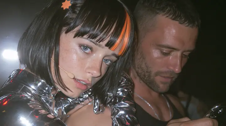 medium close-up of a Caucasian American woman in her mid-twenties with pale skin and light freckles, a glossy black blunt jaw-length bob with heavy straight bangs and one clay-orange streak through the bangs, a small…