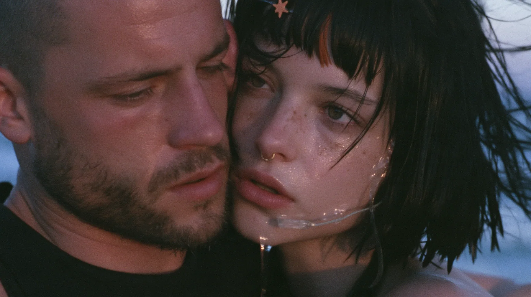 extreme close-up of a Caucasian American woman in her mid-twenties with pale skin and light freckles, a glossy black blunt jaw-length bob with heavy straight bangs and one clay-orange streak through the bangs, a…