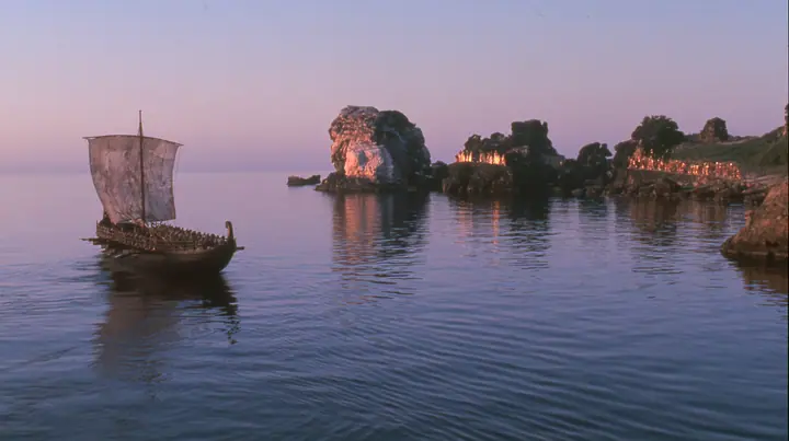 extreme wide shot from behind a long black ancient Greek galley with a single mast, a square sail and two banks of oars on a glassy sea, on the horizon a cluster of black rocks with tiny gold-lit figures of women,…