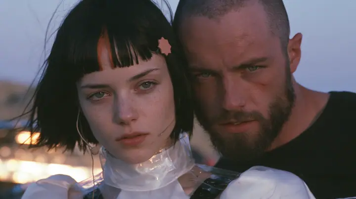 extreme close-up of a Caucasian American woman in her mid-twenties with pale skin and light freckles, a glossy black blunt jaw-length bob with heavy straight bangs and one clay-orange streak through the bangs, a…