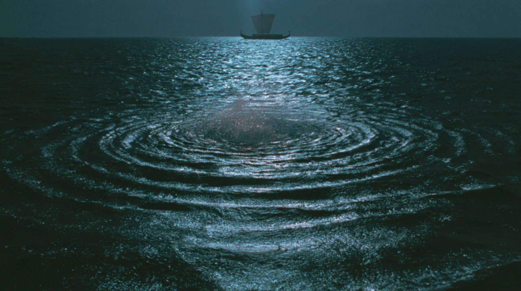 low wide shot skimming a dark moonlit sea toward a long black ancient Greek galley with a single mast, a square sail and two banks of oars in the distance, concentric ripples spreading across the water, night,…