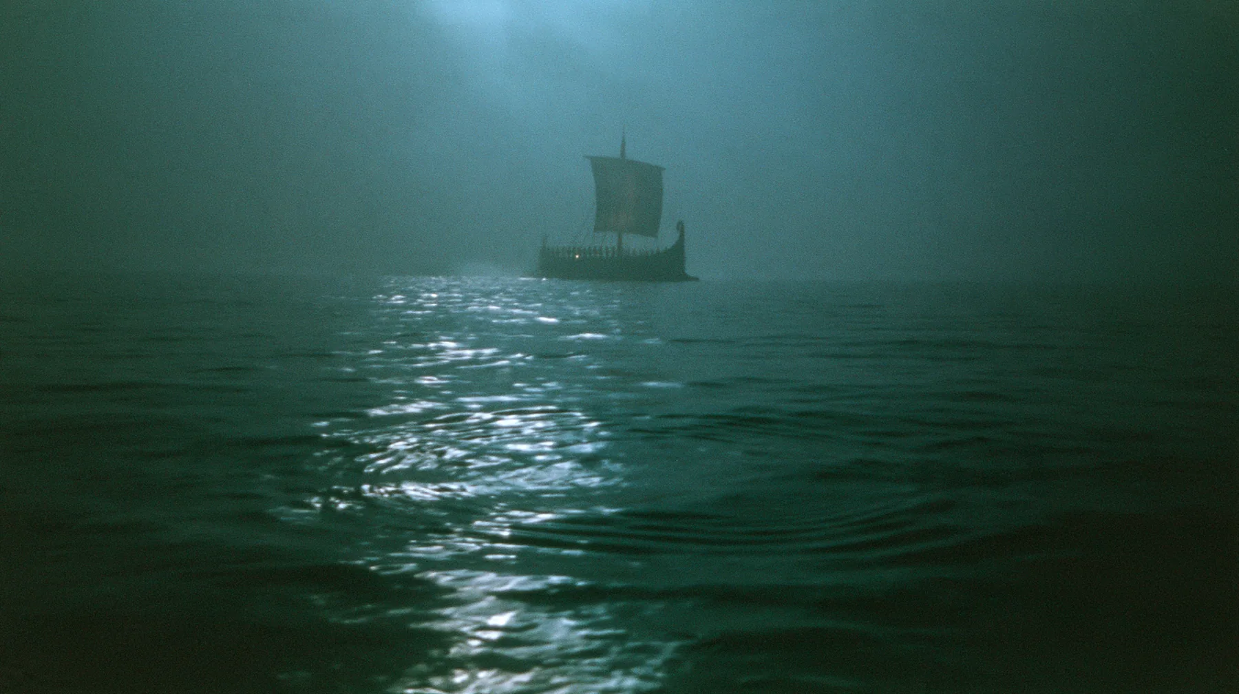 low wide shot skimming a dark moonlit sea toward a long black ancient Greek galley with a single mast, a square sail and two banks of oars in the distance, concentric ripples spreading across the water, night,…