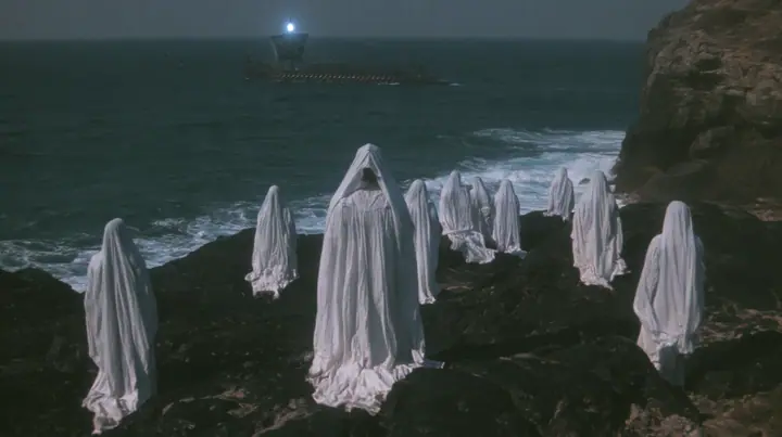 extreme wide shot from behind hundreds of women in white gowns on black sea rocks, looking out to a long black ancient Greek galley with a single mast, a square sail and two banks of oars on the far horizon, one…