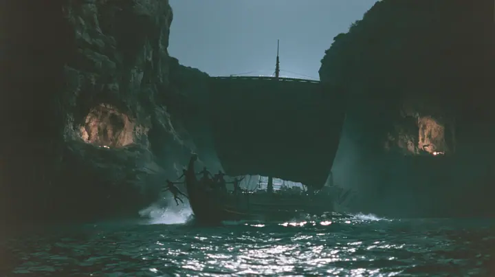 silhouettes of men leaping from both rails of a long black ancient Greek galley with a single mast, a square sail and two banks of oars into a narrow strait, cliffs of glowing alcoves behind them, night, moonlight on…