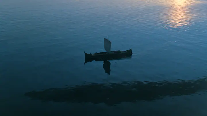 high aerial of a long black ancient Greek galley with a single mast, a square sail and two banks of oars on a darkening sea, beneath it a vast dark shadow ten times the ship's length gliding under the hull, deep blue…