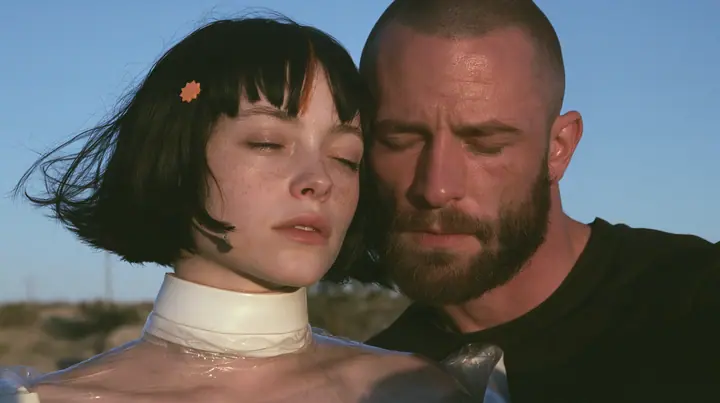 close-up of a Caucasian American woman in her mid-twenties with pale skin and light freckles, a glossy black blunt jaw-length bob with heavy straight bangs and one clay-orange streak through the bangs, a small flat…