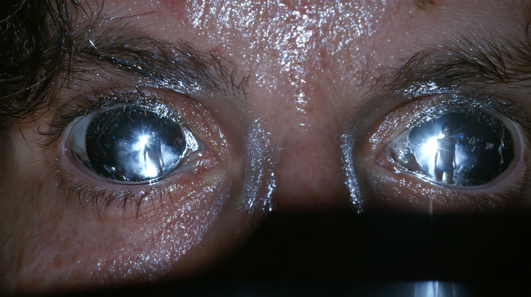 extreme close-up of a man's eyes turned to mirror chrome, reflecting a woman's silhouette, a San Francisco warehouse rave, fog, white strobe, chrome reflections, deep black, flash photography, no text, no letters, no…