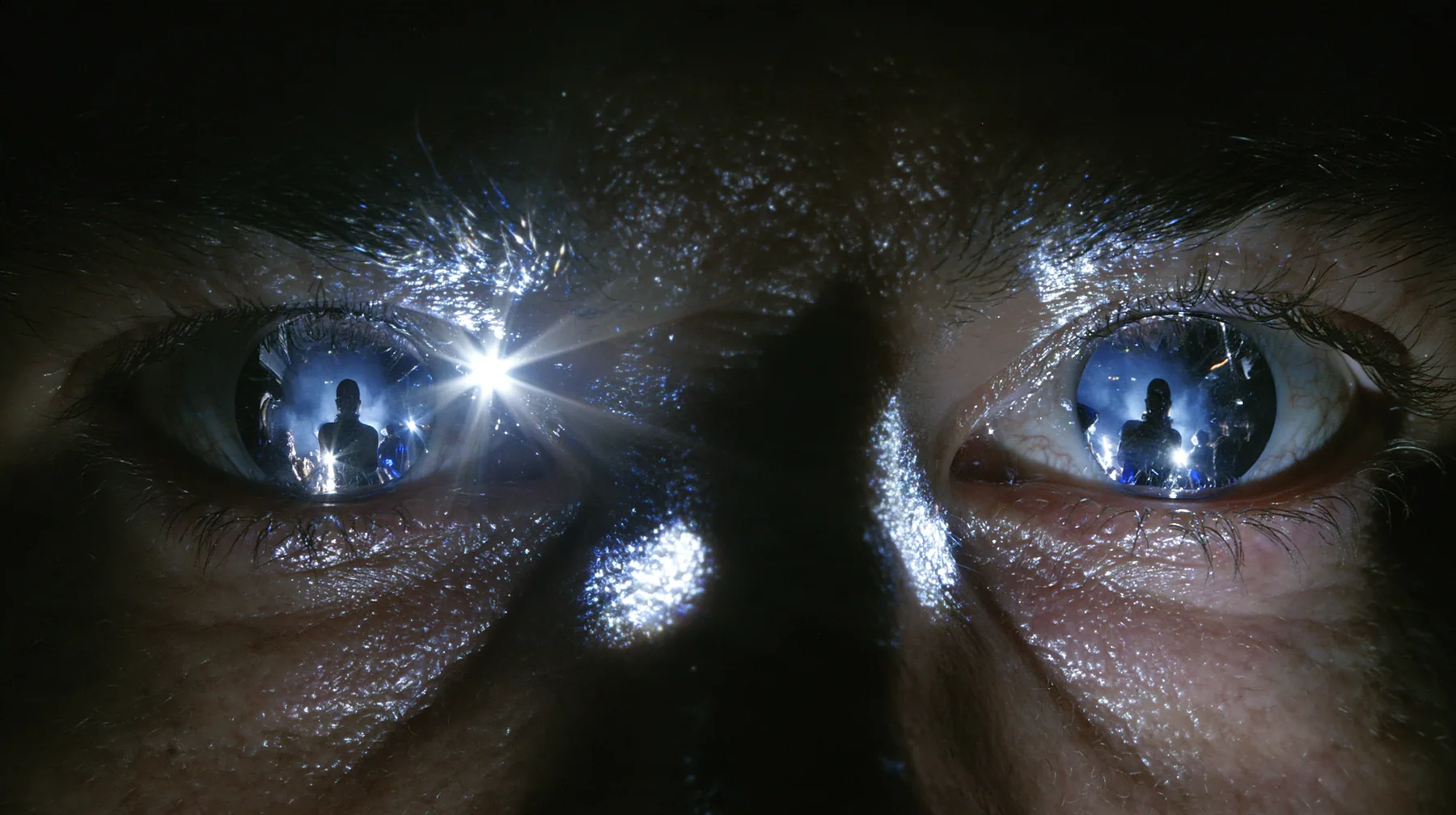 extreme close-up of a man's eyes turned to mirror chrome, reflecting a woman's silhouette, a San Francisco warehouse rave, fog, white strobe, chrome reflections, deep black, flash photography, no text, no letters, no…