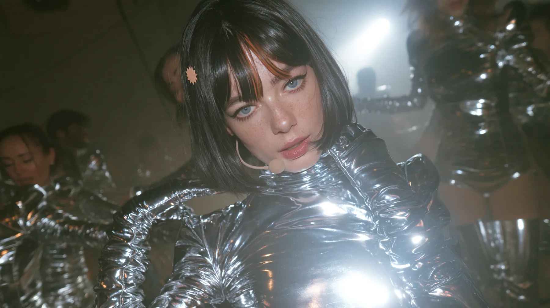 full-length shot of a Caucasian American woman in her mid-twenties with pale skin and light freckles, a glossy black blunt jaw-length bob with heavy straight bangs and one clay-orange streak through the bangs, a…