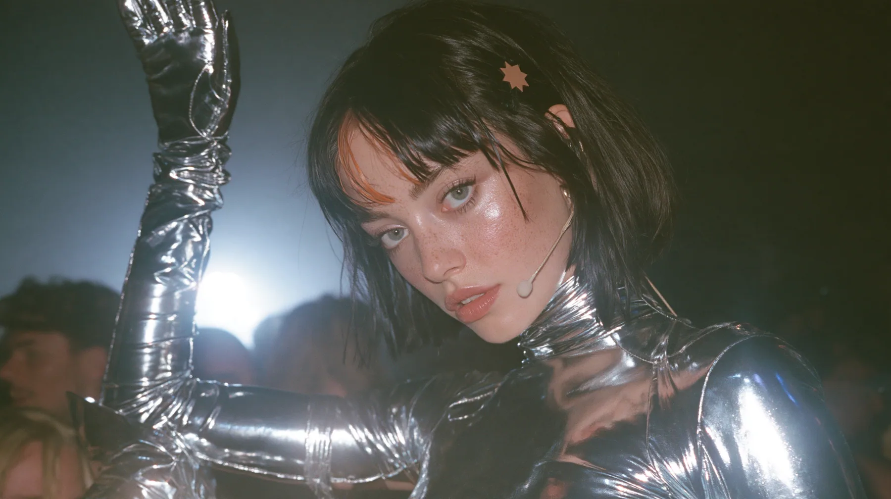 full-length shot of a Caucasian American woman in her mid-twenties with pale skin and light freckles, a glossy black blunt jaw-length bob with heavy straight bangs and one clay-orange streak through the bangs, a…