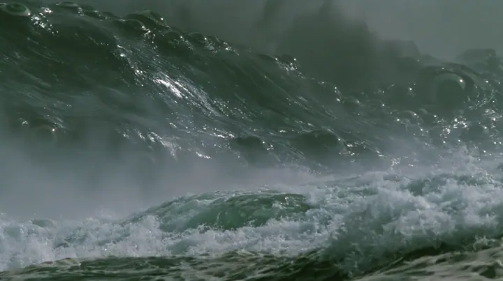 close shot of the glistening black-green flank of a colossal sea creature covered in eyes, a few of them opening, grey first light before sunrise, heavy spray, cinematic 35mm film still, anamorphic, fine grain, no…
