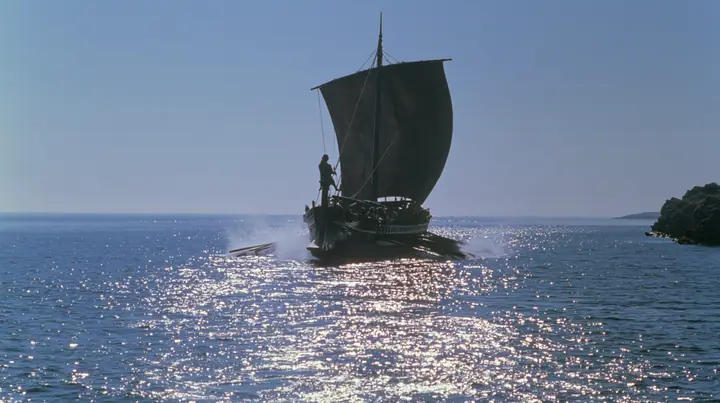 wide low shot of a long black ancient Greek galley with a single mast, a square sail and two banks of oars racing across a sparkling morning sea, oars driving in unison, spray flying, a man tied to the mast, clear…