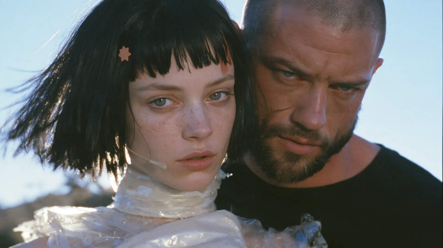 extreme close-up of a Caucasian American woman in her mid-twenties with pale skin and light freckles, a glossy black blunt jaw-length bob with heavy straight bangs and one clay-orange streak through the bangs, a…