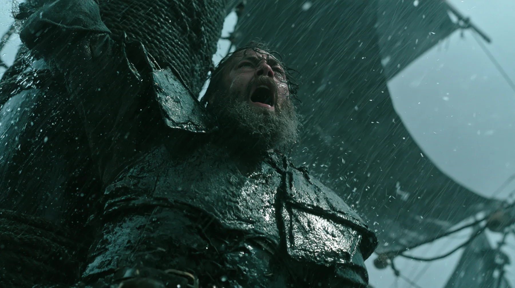 a bearded man in battered leather armour lashed to the mast of a black ship in a storm, screaming at the sky, large-format film still, practical storm, rain and spray, teal and black, no text, no letters, no logos