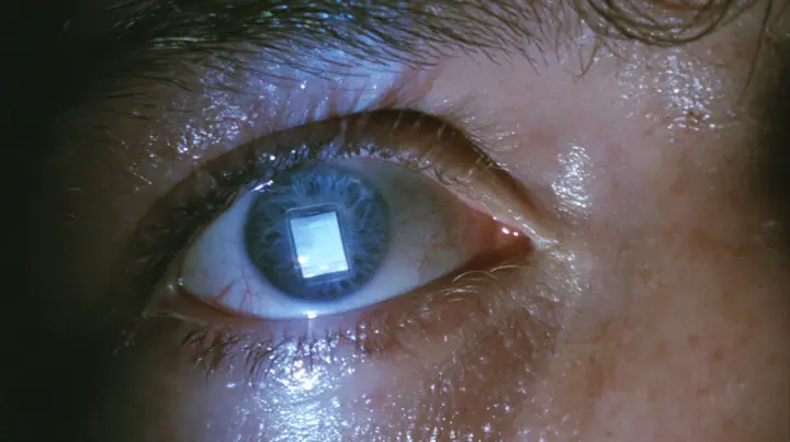 extreme close-up of a man's wide-open pale blue eye at 3am, bloodshot, heavy brow, the glowing rectangle of a phone screen reflected in the eye, a dark bedroom at 3am lit only by a phone screen, blue-white glow on…
