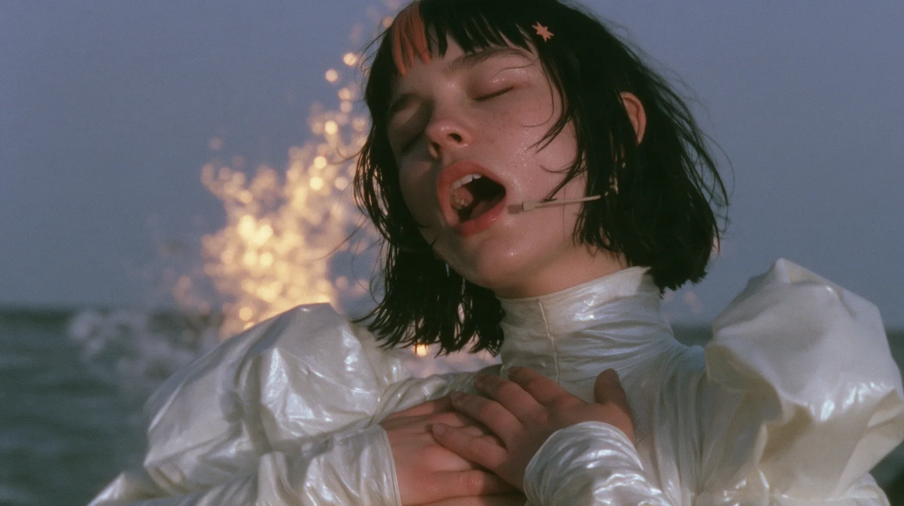 medium close-up of a Caucasian American woman in her mid-twenties with pale skin and light freckles, a glossy black blunt jaw-length bob with heavy straight bangs and one clay-orange streak through the bangs, a small…