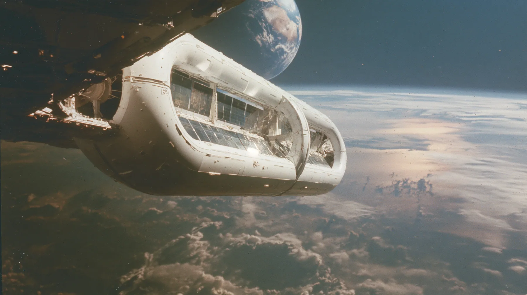A 35 mm photograph of a huge white O'Neill cylinder space colony floating in space, shaped like a capsule, long mirror panels catching the sun, the Earth glowing beyond, stars, in the style of the 1975 NASA space…