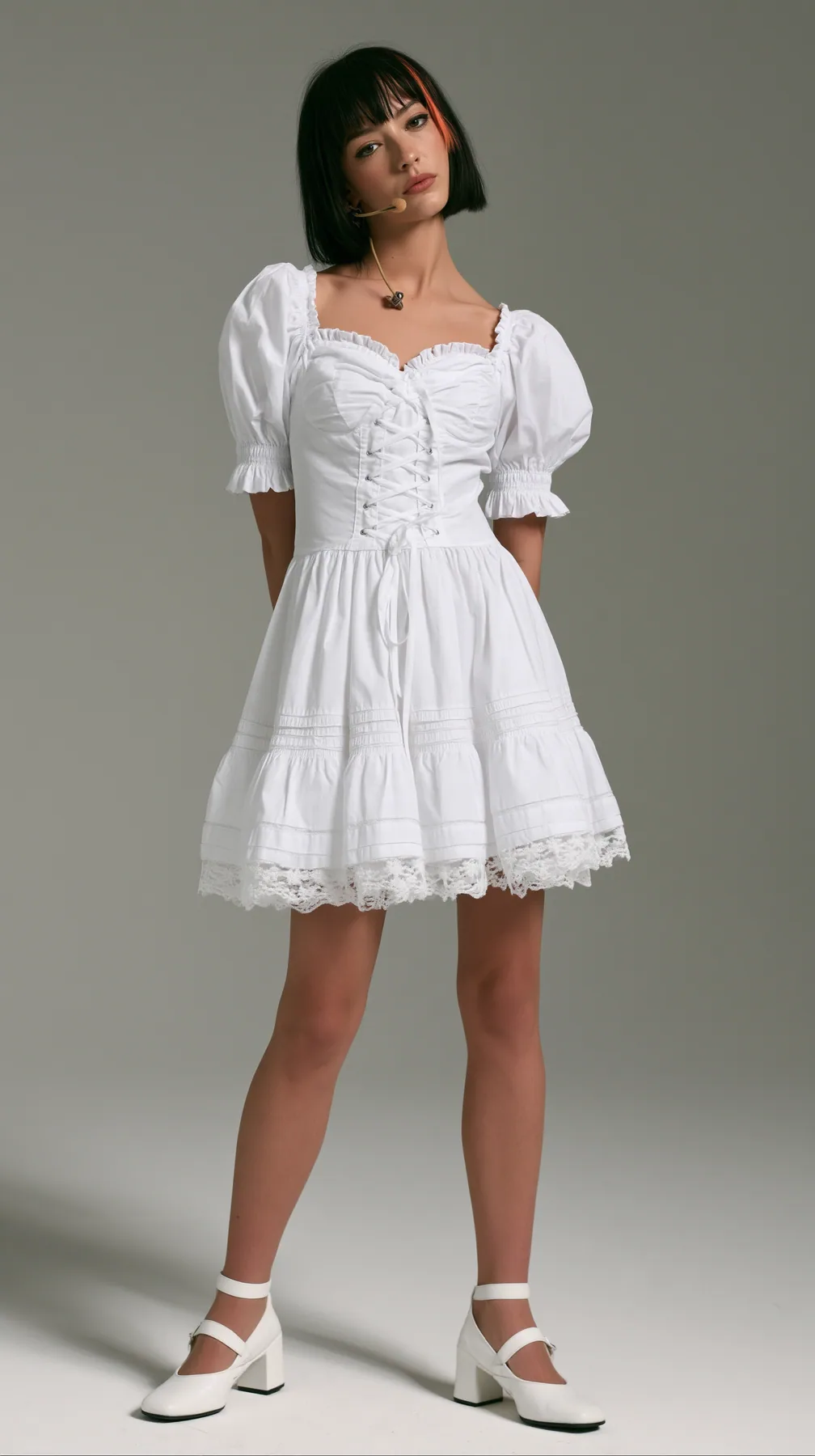 Dress this woman in a white cotton milkmaid mini dress: sweetheart neckline, lace-up bodice, puff sleeves, tiered skirt to mid-thigh with lace trim; white heeled Mary Janes. Keep her face, her black bob with the…