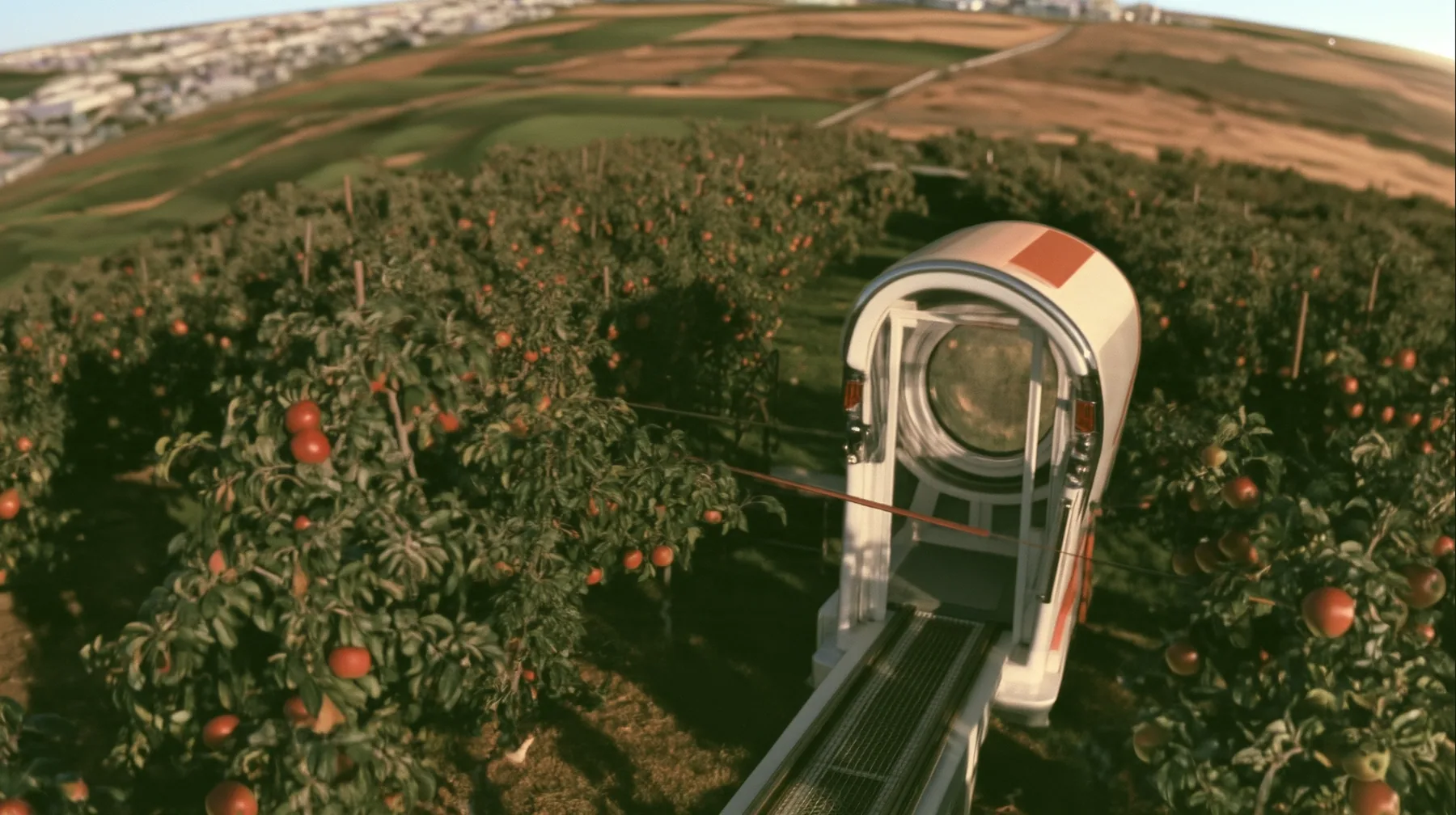 Make this the same photograph with nobody in it: remove the woman and continue the scene behind her where she stood. Keep everything else exactly: the little white tram on its rail, now empty, and the apple orchard…