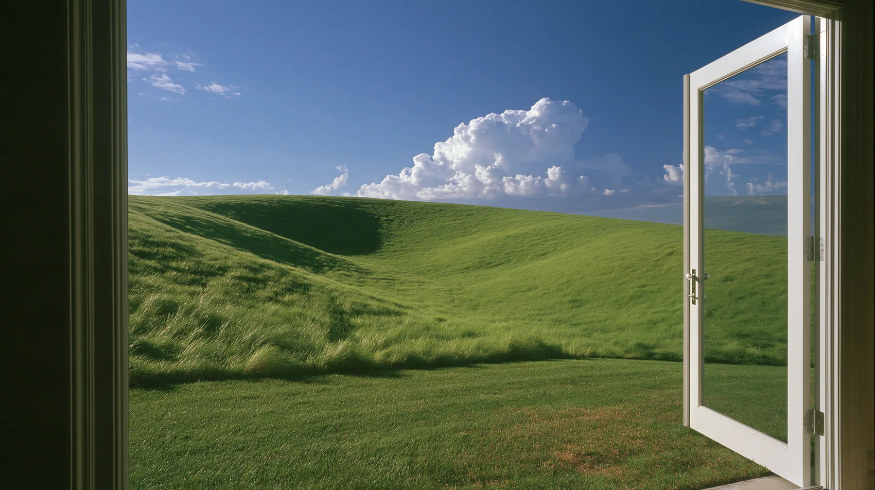 Y2K high fashion editorial photograph, 2001: first-person view stepping out of a white door onto a sunny manicured lawn, a smooth rolling bright-green grassy hill with soft curves, the grass short and velvety rising…