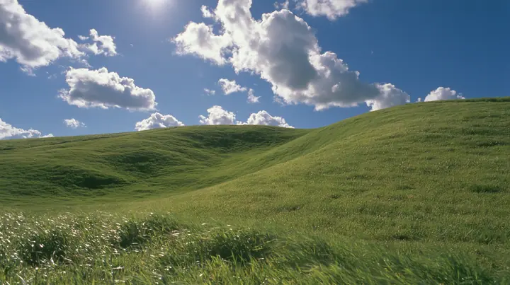 Y2K high fashion editorial photograph, 2001: first-person view walking up a smooth rolling bright-green grassy hill with soft curves, the grass short and velvety, the grass rushing past at the bottom of frame, the…