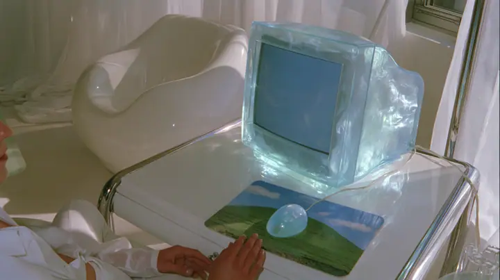 Y2K high fashion editorial photograph, 2001: first-person view from a chair at a 2001 high-fashion minimalist white loft apartment with molded white plastic furniture, a white lacquer desk, chrome and translucent…
