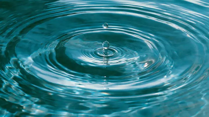 Y2K high fashion editorial photograph, 2001: a luxury beauty-campaign macro of a single drop rippling in calm turquoise water, glossy concentric rings, medium-format, no text, no letters, no logos