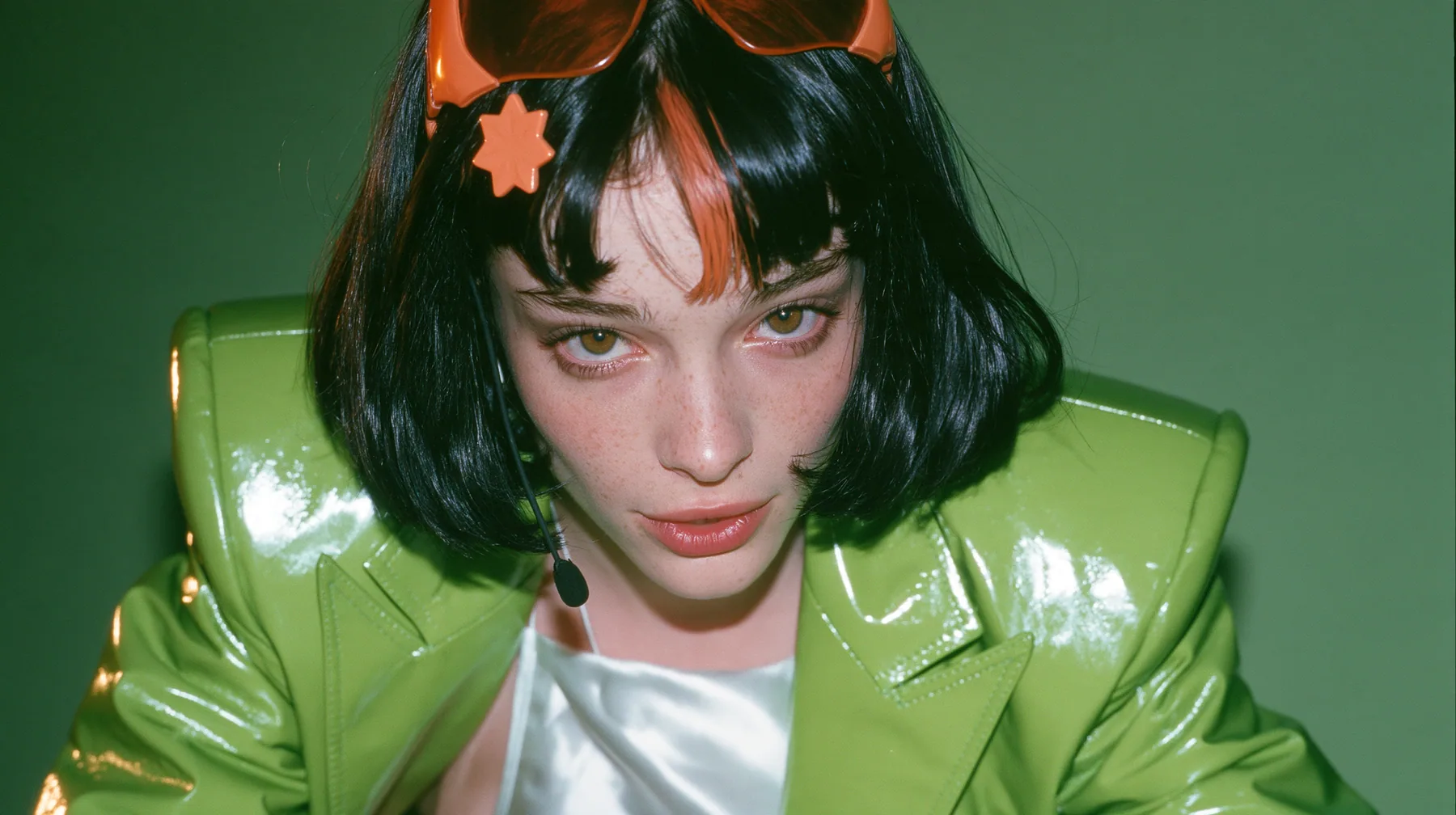 Y2K high fashion editorial, 2001: a medium close-up of a Caucasian American woman in her mid-twenties with pale skin and light freckles, a glossy black blunt jaw-length bob with heavy straight bangs and one…