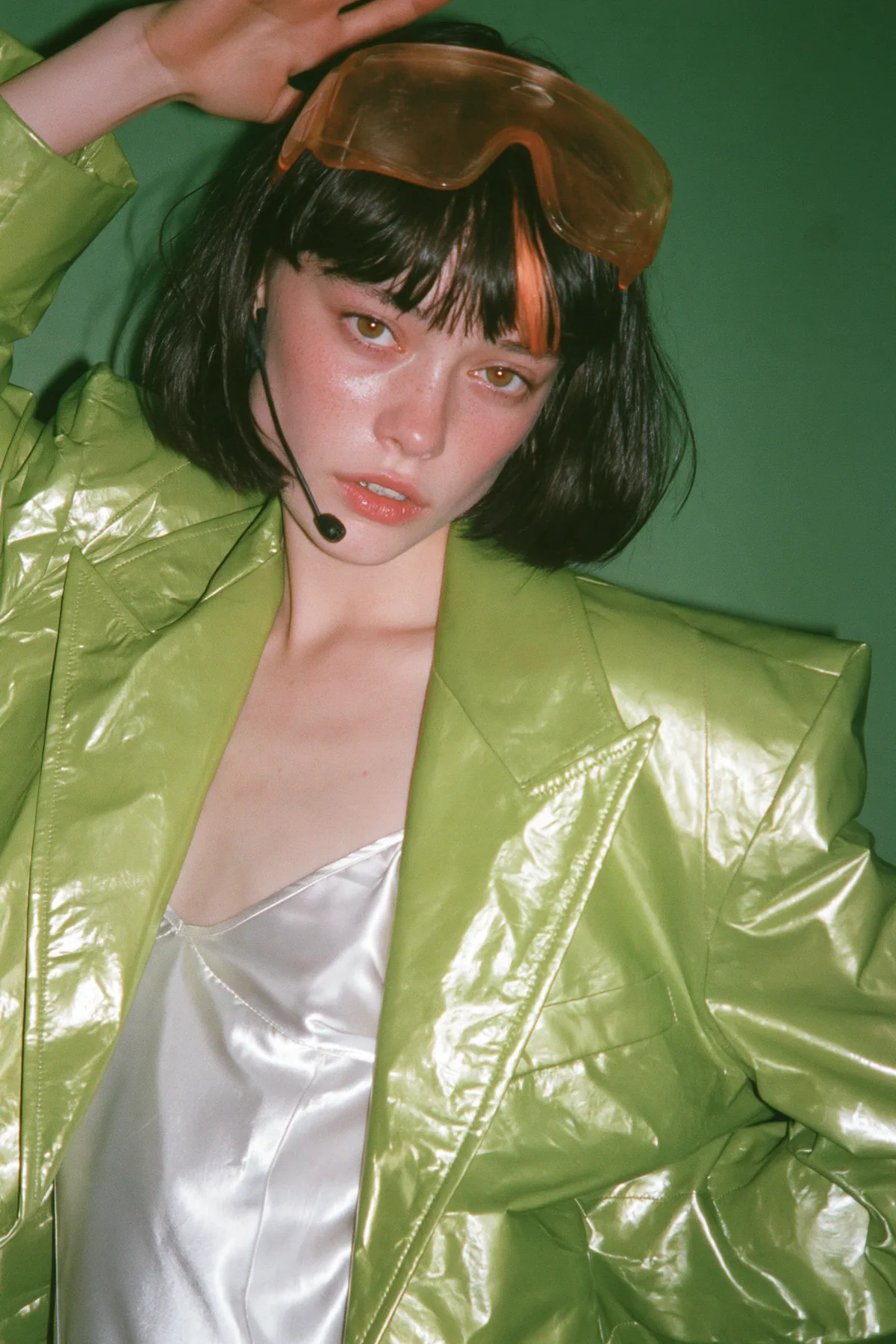 Y2K high fashion editorial, a 2001 couture magazine story: full-length shot, head to toe with the feet in frame, of a young Caucasian American woman with pale skin and a glossy black blunt bob with heavy straight…