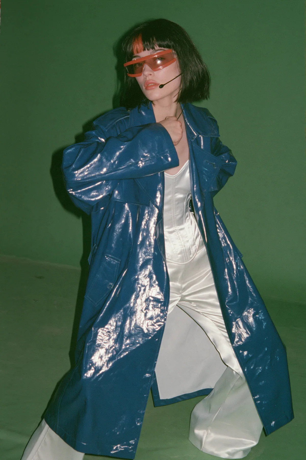 Y2K high fashion editorial, a 2001 couture magazine story: full-length shot, head to toe with the feet in frame, of a young Caucasian American woman with pale skin and a glossy black blunt bob with heavy straight…