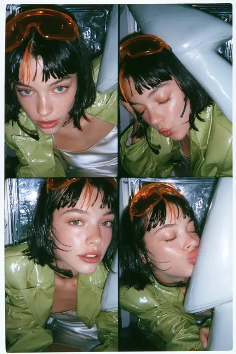 Y2K high fashion editorial, a 2001 couture magazine story: a vertical photo-booth strip of four frames of a young Caucasian American woman with pale skin and a glossy black blunt bob with heavy straight bangs and one…